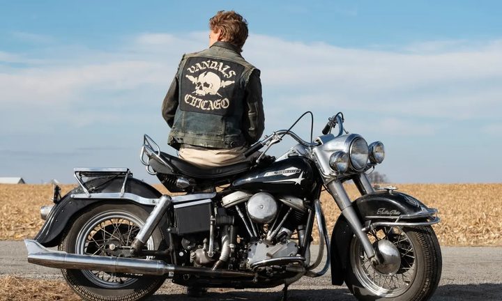 A man sits on a bike in The Bikeriders.