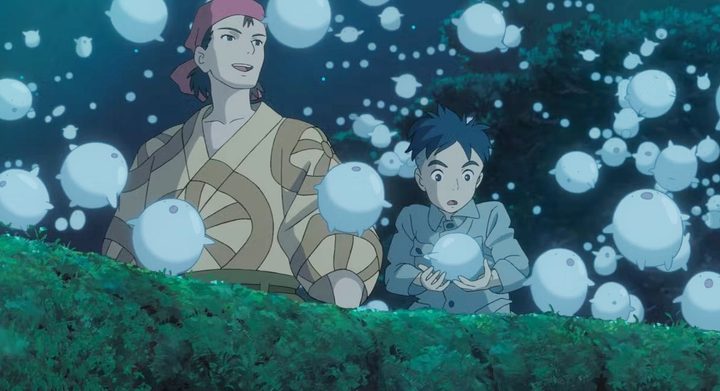 A boy and man encounter creatures in The Boy and the Heron.