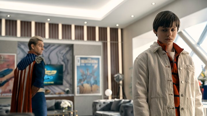 Ryan in the forefront in Homelander's home, Homelander looking back at him on The Boys.