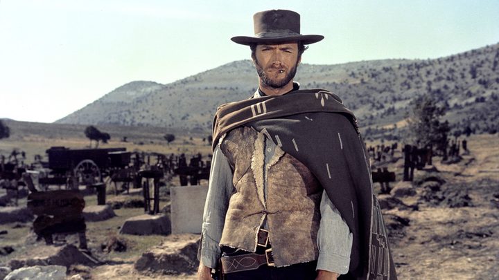 Clint Eastwood standing in the desert wearing a hat and looking directly at the camera in The Good, The Bad and the Ugly.
