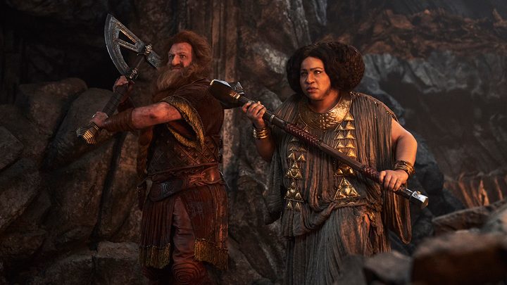 Two people carrying weapons and ready to fight in The Lords of the Rings: The Rings of Power