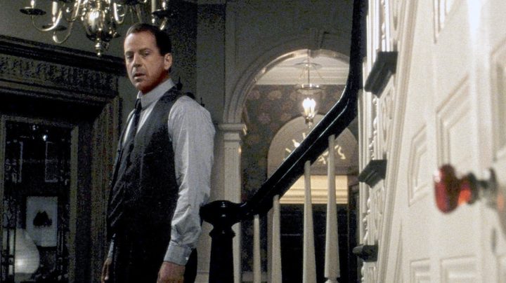 A man looks at a door knob in The Sixth Sense.