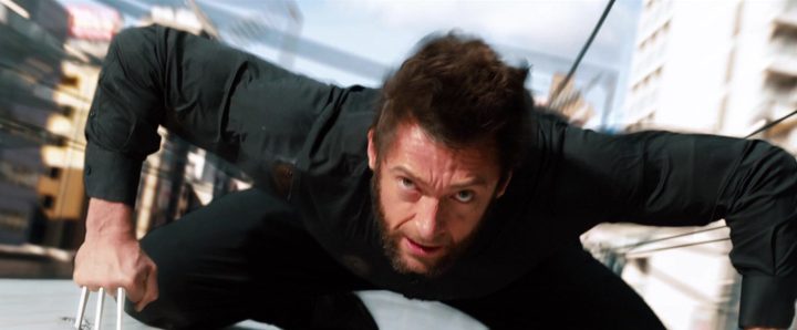 Logan (Hugh Jackman) clings to the top of a speeding train in The Wolverine.