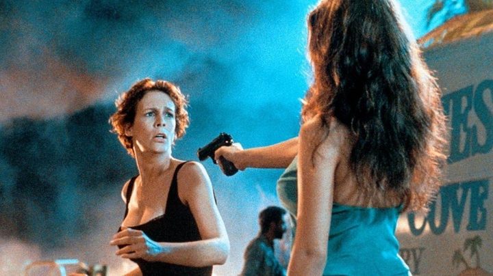 A woman aims a gun at another woman in True LIes.