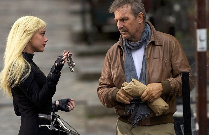 A woman talks to a man in 3 Days to Kill.