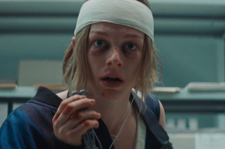 A bandaged Hunter Schafer holds a butterfly knife in Cuckoo.