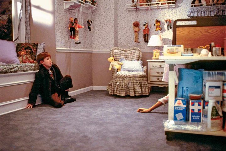 A hand reaches toward Haley Joel Osment in The Sixth Sense.
