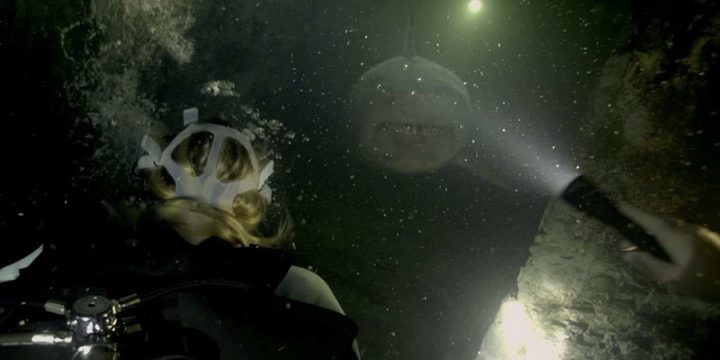 A shark swims towards divers in 47 Meters Down Uncaged