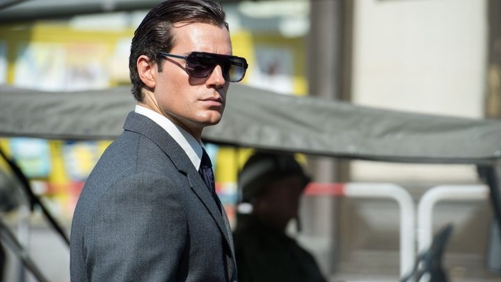 Henry Cavill as Napoleon Solo wearing shades and looking to his right in The Man From UNCLE.