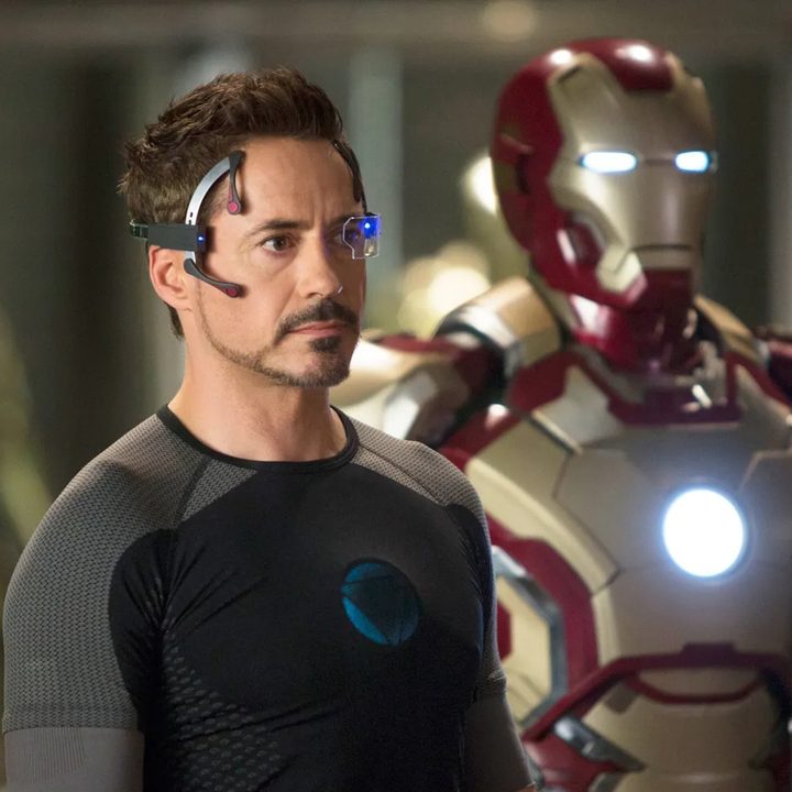 Robert Downey Jr. stands in front of his Iron Man suit in a still from the movie Iron Man 3.