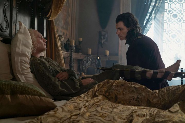 Loras Strong sits with a wounded Aegon II Targaryen in House of the Dragon season 2.