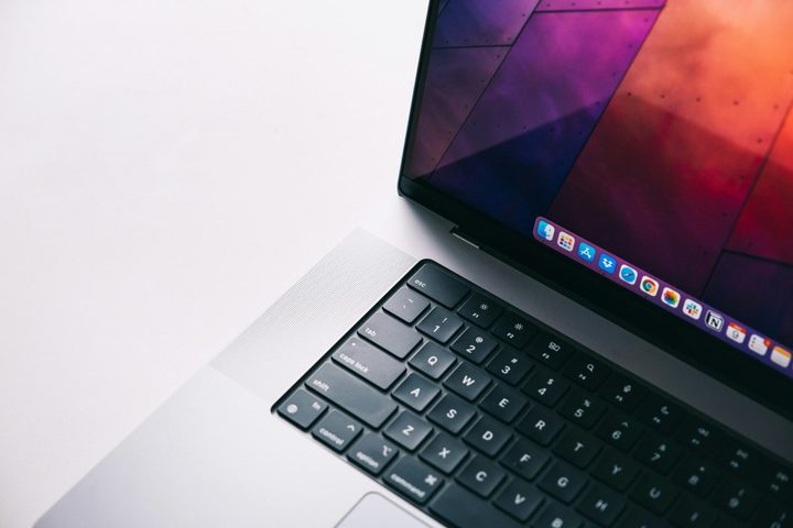 A close up of a MacBook Pro against a white background.