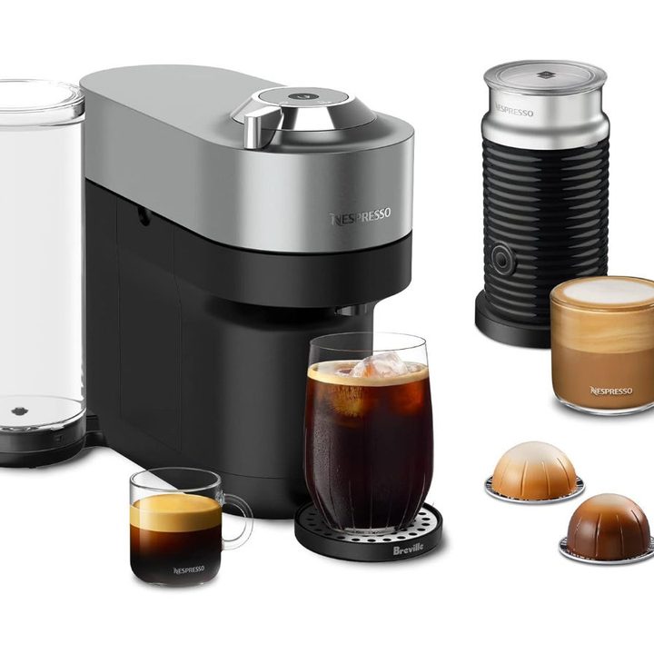 The Nespresso Vertuo POP+ Deluxe Coffee and Espresso Machine and accessories against a white background.