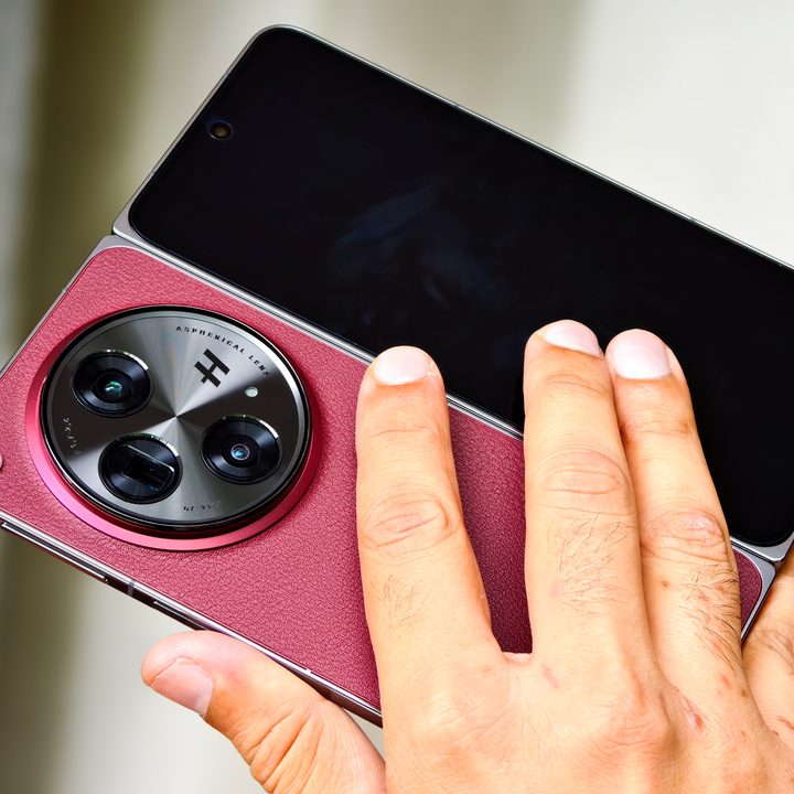 OnePlus Open Apex Edition Crimson Shadow red one held in one hand.