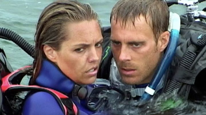 Blanchard Ryan and Daniel Travis huddle close in their wetsuits in a still from the movie Open Water.