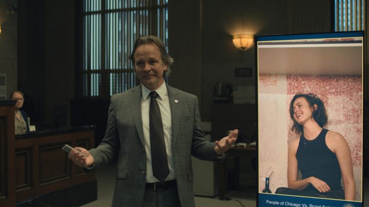 A lawyer holds his hands up in the court room in Presumed Innocent.