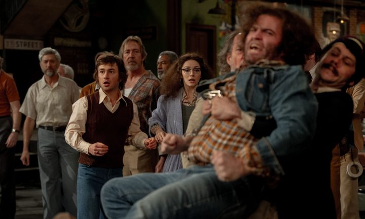 The cast of Saturday Night Live stand together and watch.