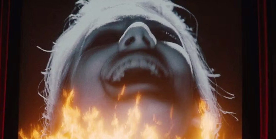 A woman on a cinema screen laughs in Inglourious Basterds.