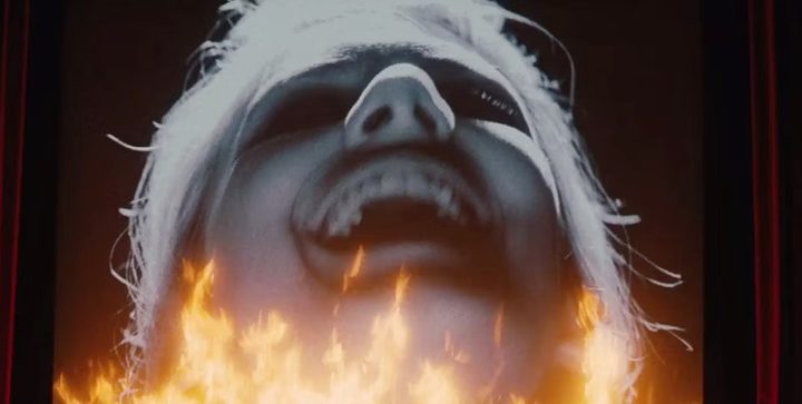 A woman on a cinema screen laughs in Inglourious Basterds.
