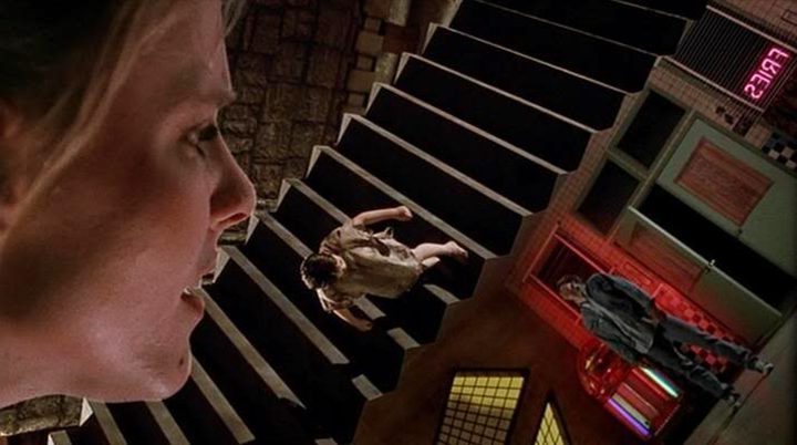 A woman looks at a maze with people in it in A Nightmare on Elm Street 5: The Dream Child.