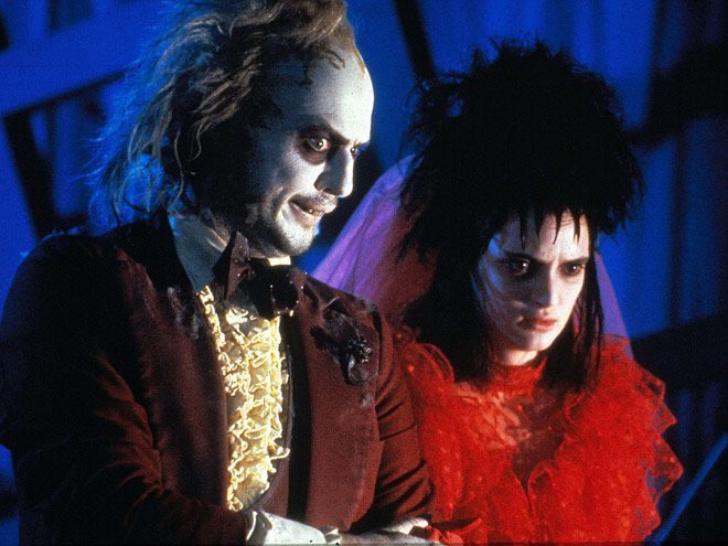 Michael Keaton and Winona Ryder approach the altar in Beetlejuice.