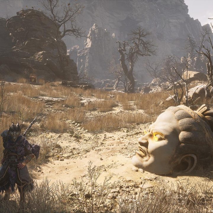 The image shows the player standing near a statue head that has a Buddha's Eyeball item.