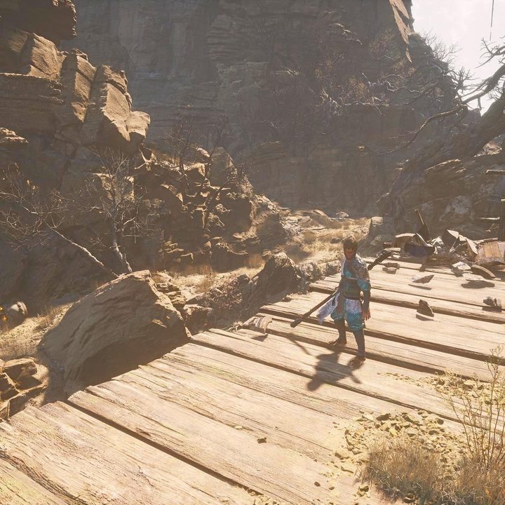 The image shows the player standing near a statue head that has a Buddha's Eyeball. Another statue head can be seen in the distance.