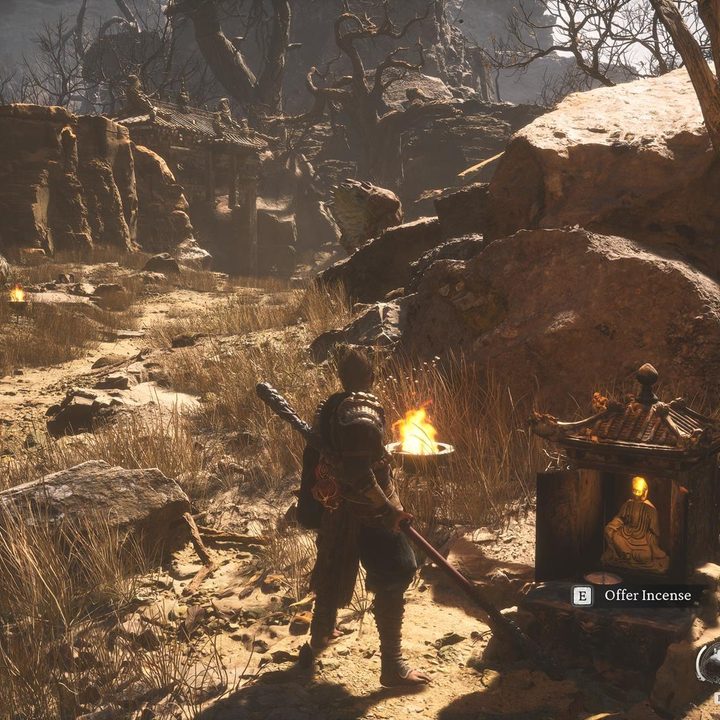 The image shows the player looking at a statue head in the distance.