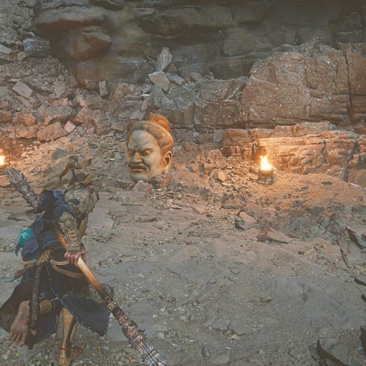 The image shows the player running toward a statue head.