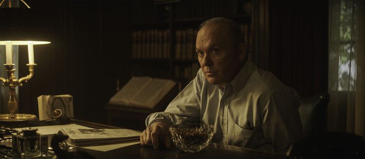 Michael Keaton as Attorney General Ramsey Clark in The Trial of the Chicago 7.