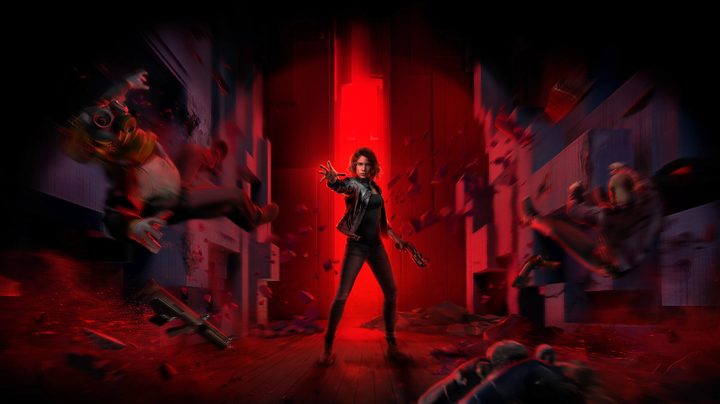 Jesse from Control stands in front of a red backdrop.