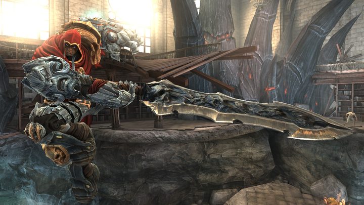 War, a large man with a red hood and massive armor, with a giant sword about to swing into battle in the first Darksiders.
