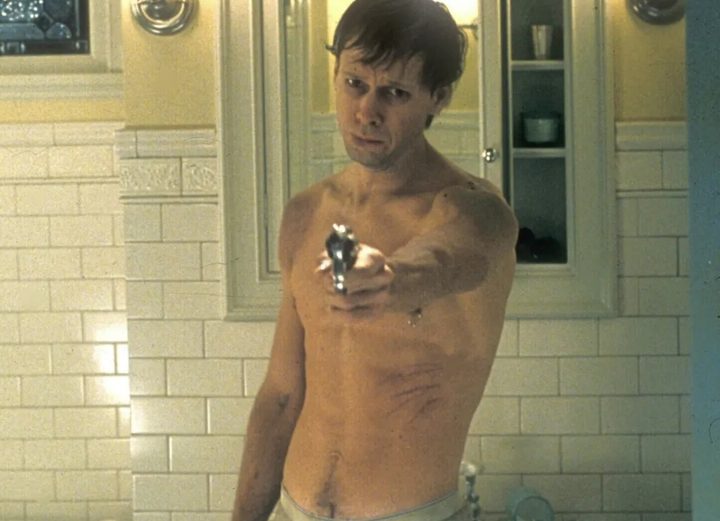 A nude man points a gun in The Sixth Sense.