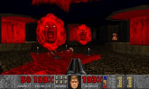 A first person view in Doom, with a gun pointed at two floating red screaming heads.