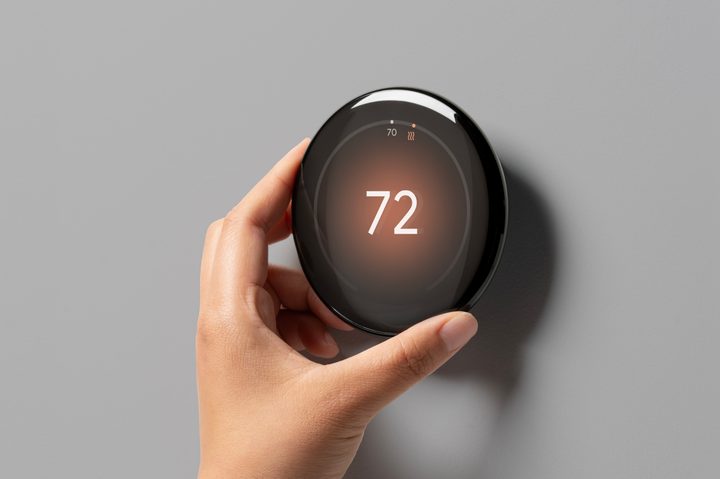 Someone adjusting the temperature on the Google Nest Learning Thermostat (4th Gen).