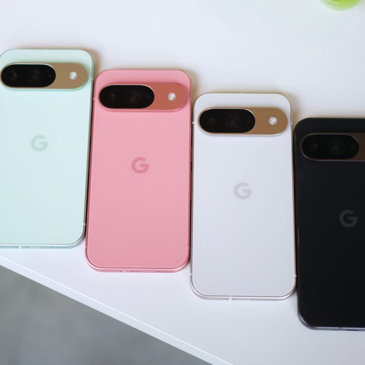 The Google Pixel 9 in green, pink, white, and black colors, all laying on a white table.