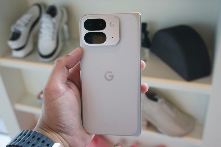 Someone holding the Google Pixel 9 Pro Fold and showing the back of the phone.