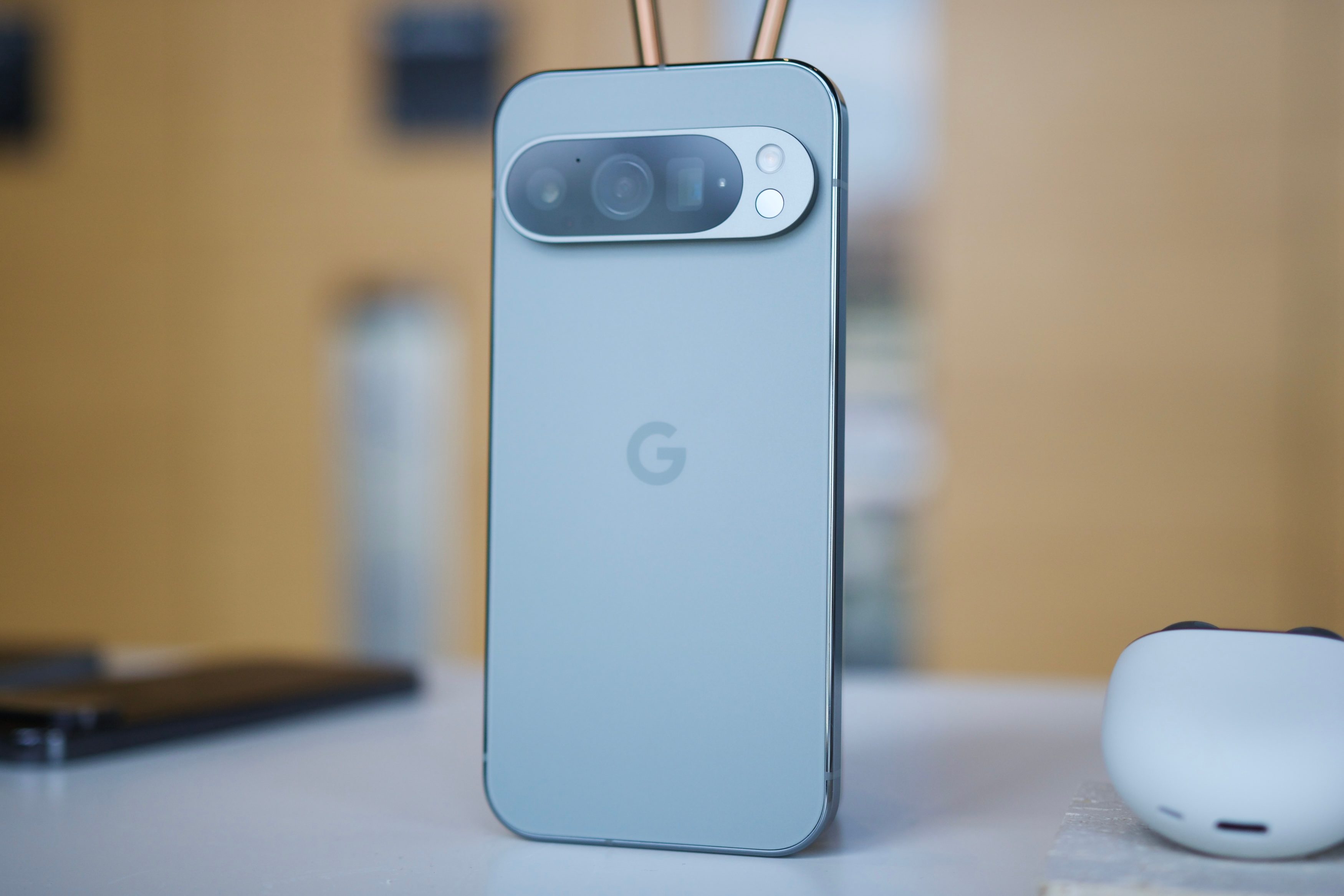 The Google Pixel 9 Pro standing upright on a table.