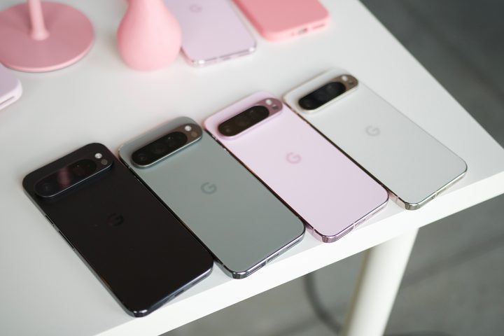 All four colors of the Google Pixel 9 Pro XL laying next to each other on a white table.