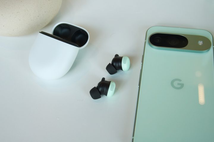 The Google Pixel Buds Pro 2 next to their charge case and a Pixel 9.