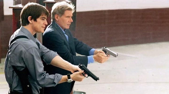Two men point their guns in Hollywood Homicide.