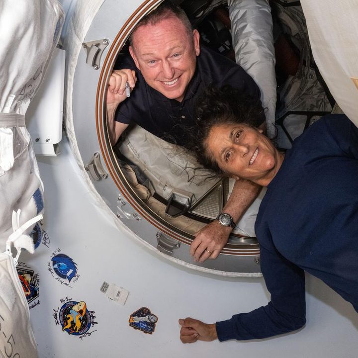 NASA’s Boeing Crew Flight Test astronauts (from top) Butch Wilmore and Suni Williams pose on June 13, 2024 for a portrait inside the vestibule between the forward port on the International Space Station’s Harmony module and Boeing’s Starliner spacecraft.