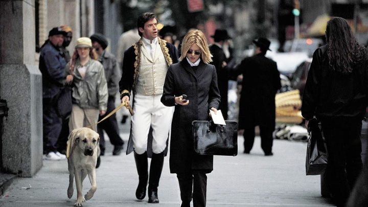 A man walks a dog behind a woman in Kate & Leopold.