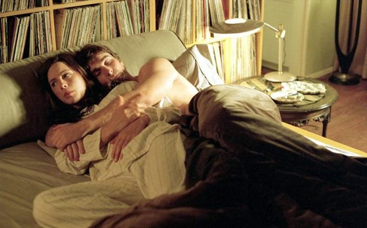 A man holds a woman in bed in Laurel Canyon.