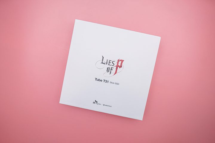 Lies of P Tube T31 box on a pink background.