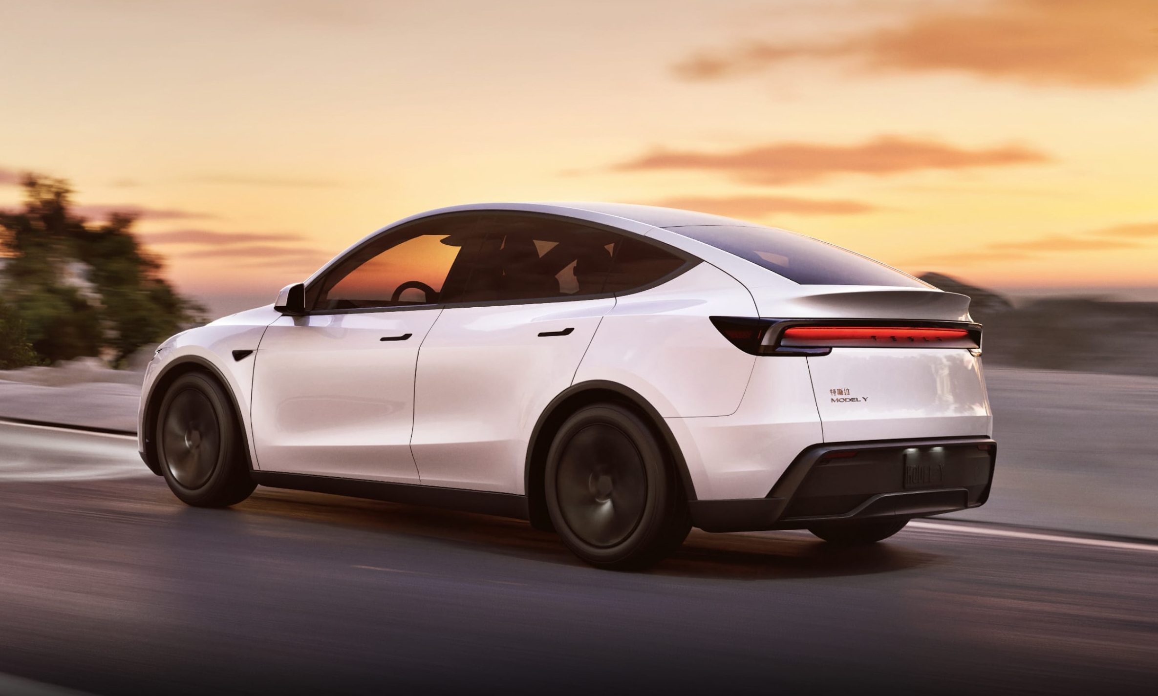 White Tesla Model Y Juniper driving