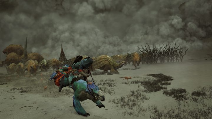 A hunter runs from a dust storm in Monster Hunter Wilds.