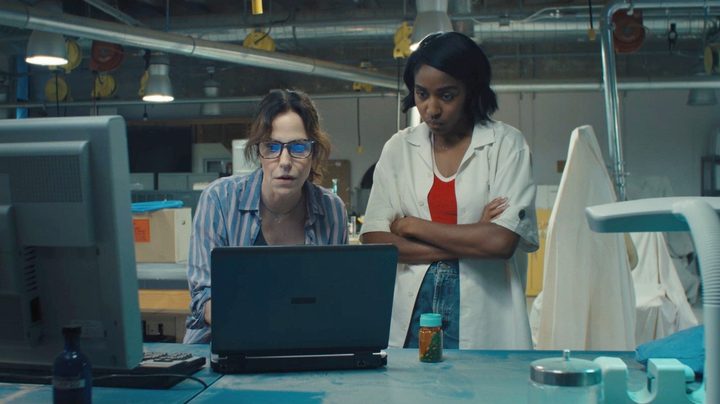 Two women look at a computer in Omni Loop.