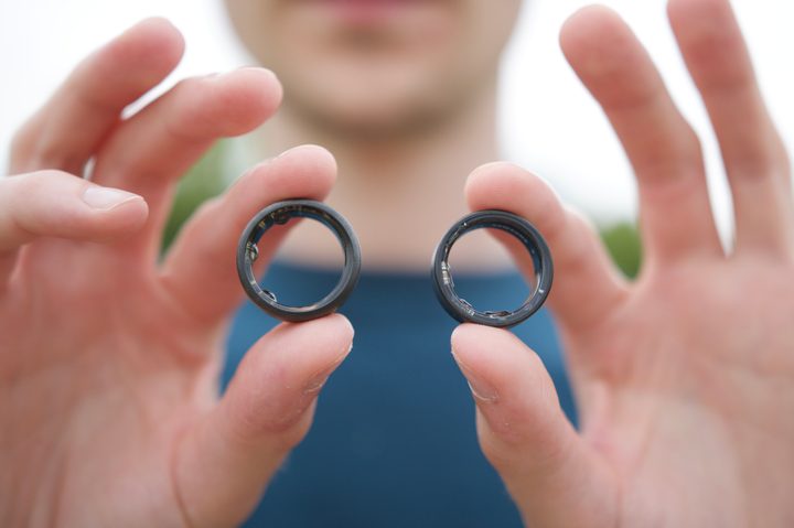 Someone holding the Samsung Galaxy Ring and the Oura Ring.