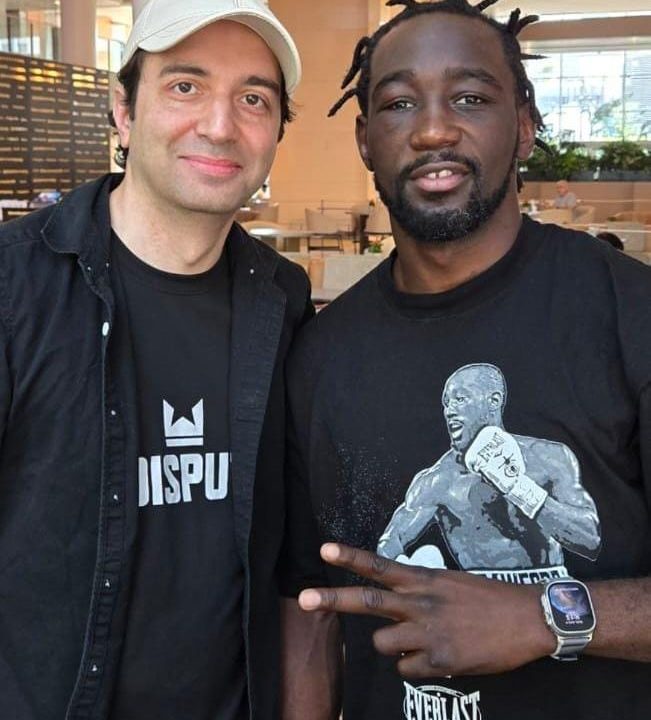 Undisputed creator Ash Habib stands next to Terence Crawford, who is flashing a victory sign.